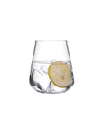 NUDE Salute lead-free crystal tumbler filled with water, ice and a lemon slice on a white background