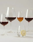 NUDE Salute crystal glassware collection with red wine, Burgundy, sherry glasses and a tumbler with lemon