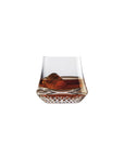 NUDE Paris whisky glass DOF, presented filled with whisky on a white background