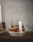NUDE Paris whisky glass SOF, presented filled with whisky on table with grey background