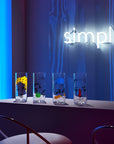 Lifestyle image of NUDE Rock & Pop high ball glasses in neon environment