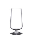 NUDE | Tom Dixon Splash Highball glass, empty, shown on a plain white background, showing its tall tapered bowl and ripple foot base.