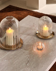 Lead-free crystal candle holder Ilo, a dome shaped candle holder with rippled glass effect, with candle presented on a table with the small version of candle holder and a votive version of similar design